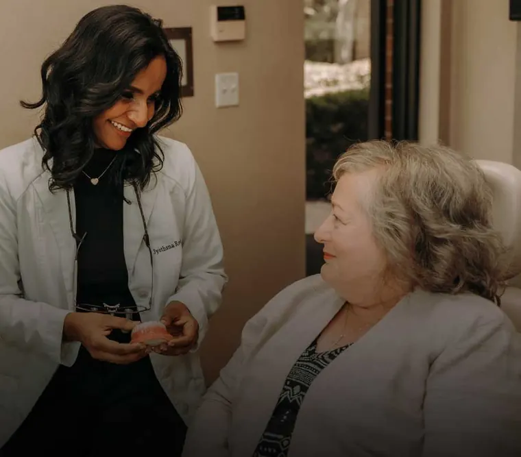 Dr. Reddy talking with a patient in the treatment room